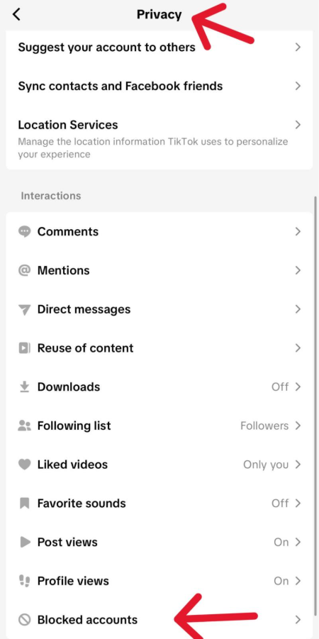 TikTok Privacy settings page showing various options. A red arrow points to Blocked accounts at the bottom of the list.