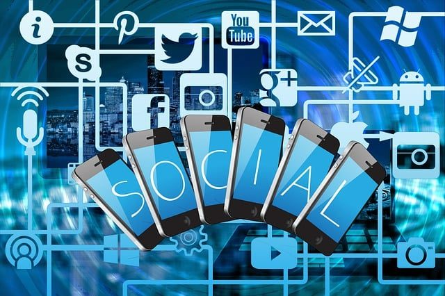 Phones spelling SOCIAL surrounded by social media icons